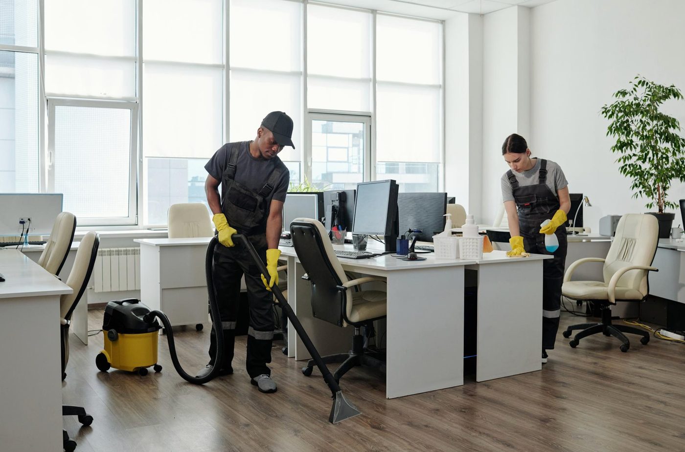 Commercial office cleaners vacuuming and sanitising a Birmingham office