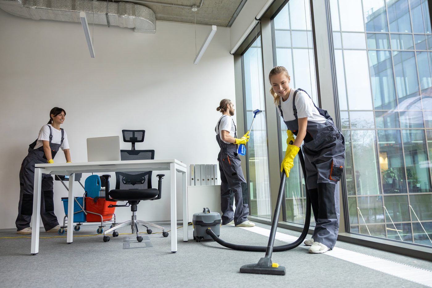 Cleaning team vacuuming and cleaning windows in a Birmingham office