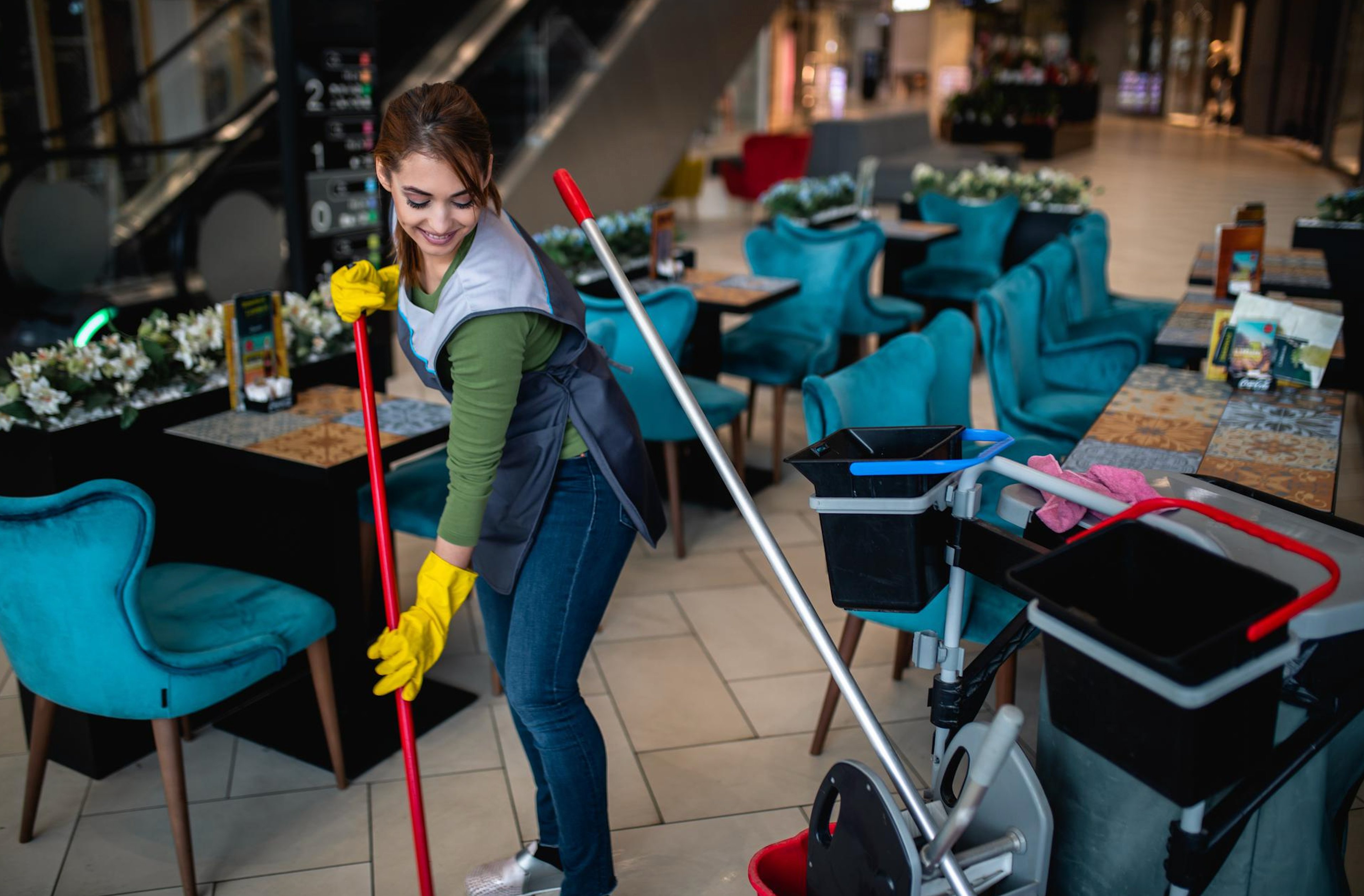 Professional cleaner mopping restaurant floor in Birmingham